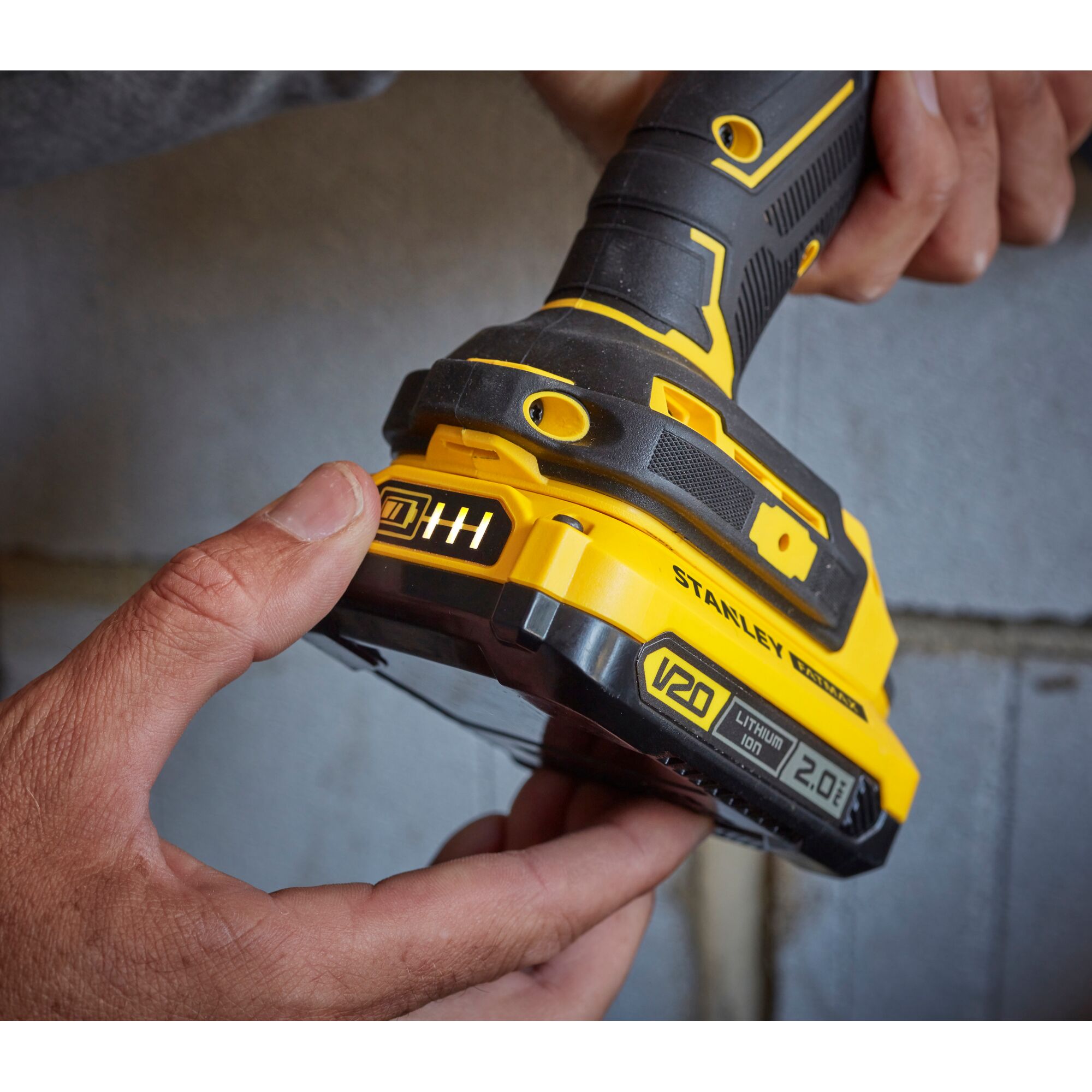 Photo of STANLEY SB202 cordless power tool with V20 2.0Ah lithium-ion battery, close-up angle.