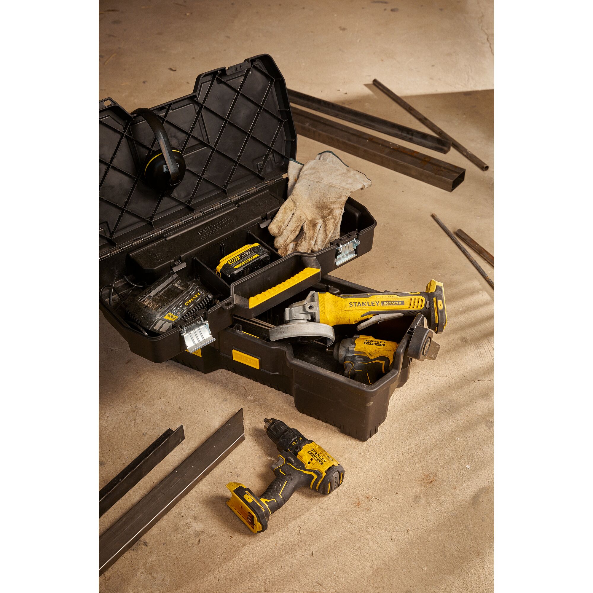STANLEY SB204-KR photography of yellow tool kit with cordless drill, grinder, gloves and battery charger.