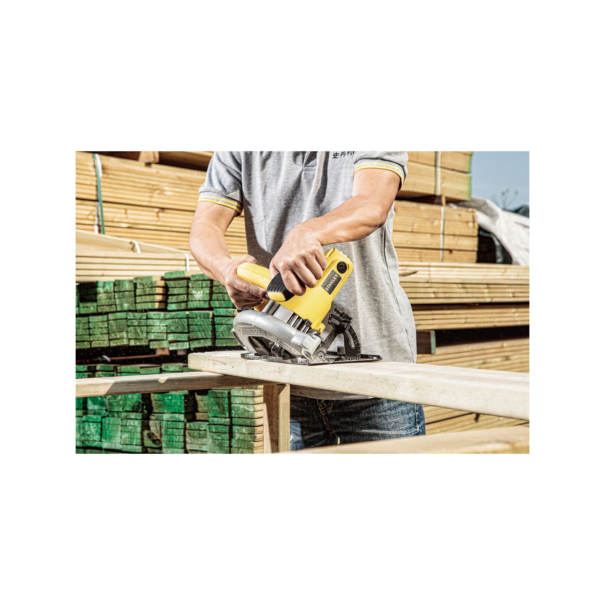 STANLEY SC16 circular saw in use cutting wood, shown outdoors at a lumber yard.