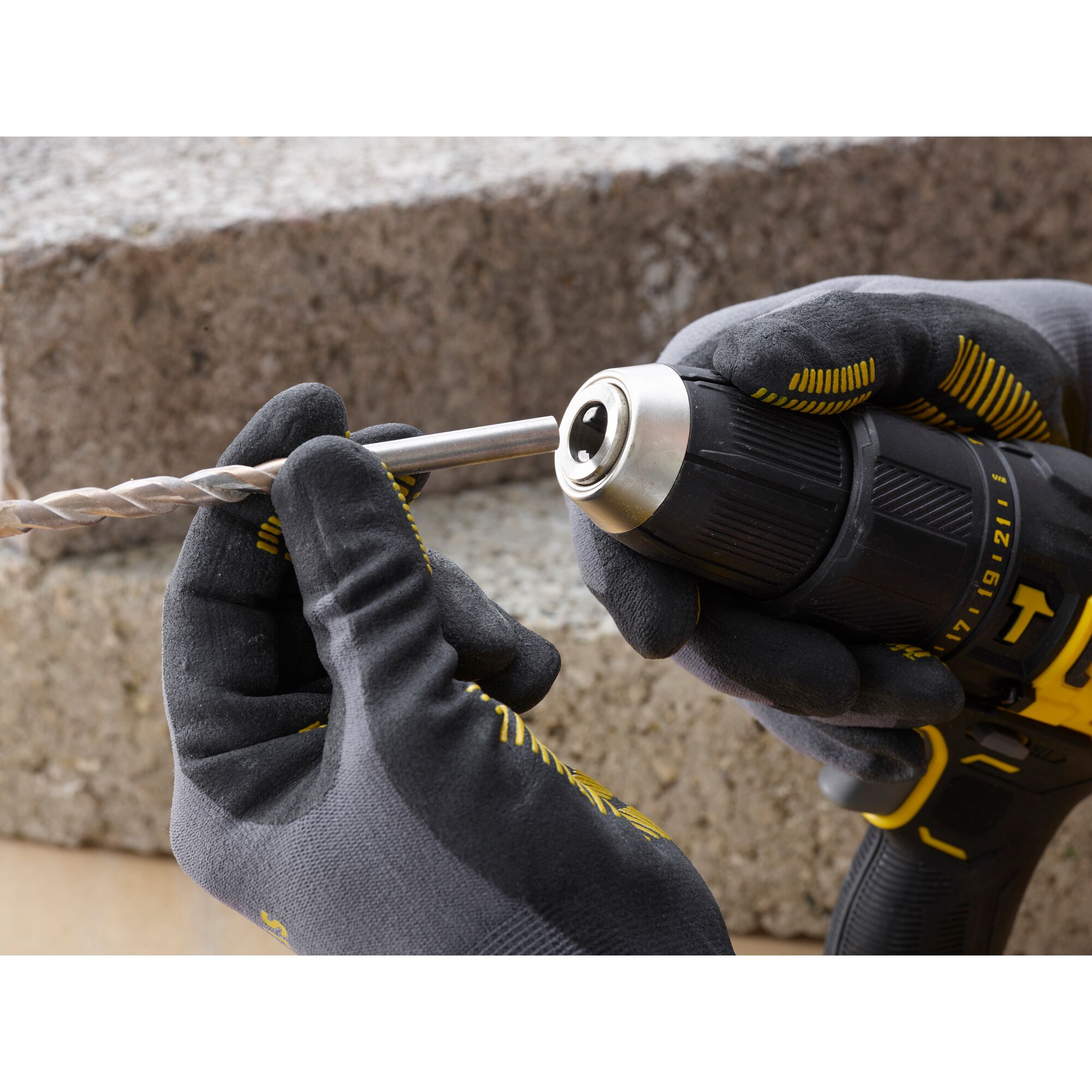 STANLEY SCD711C1H-B2__SCD711C1H drill photography, close-up of gloved hands inserting drill bit.