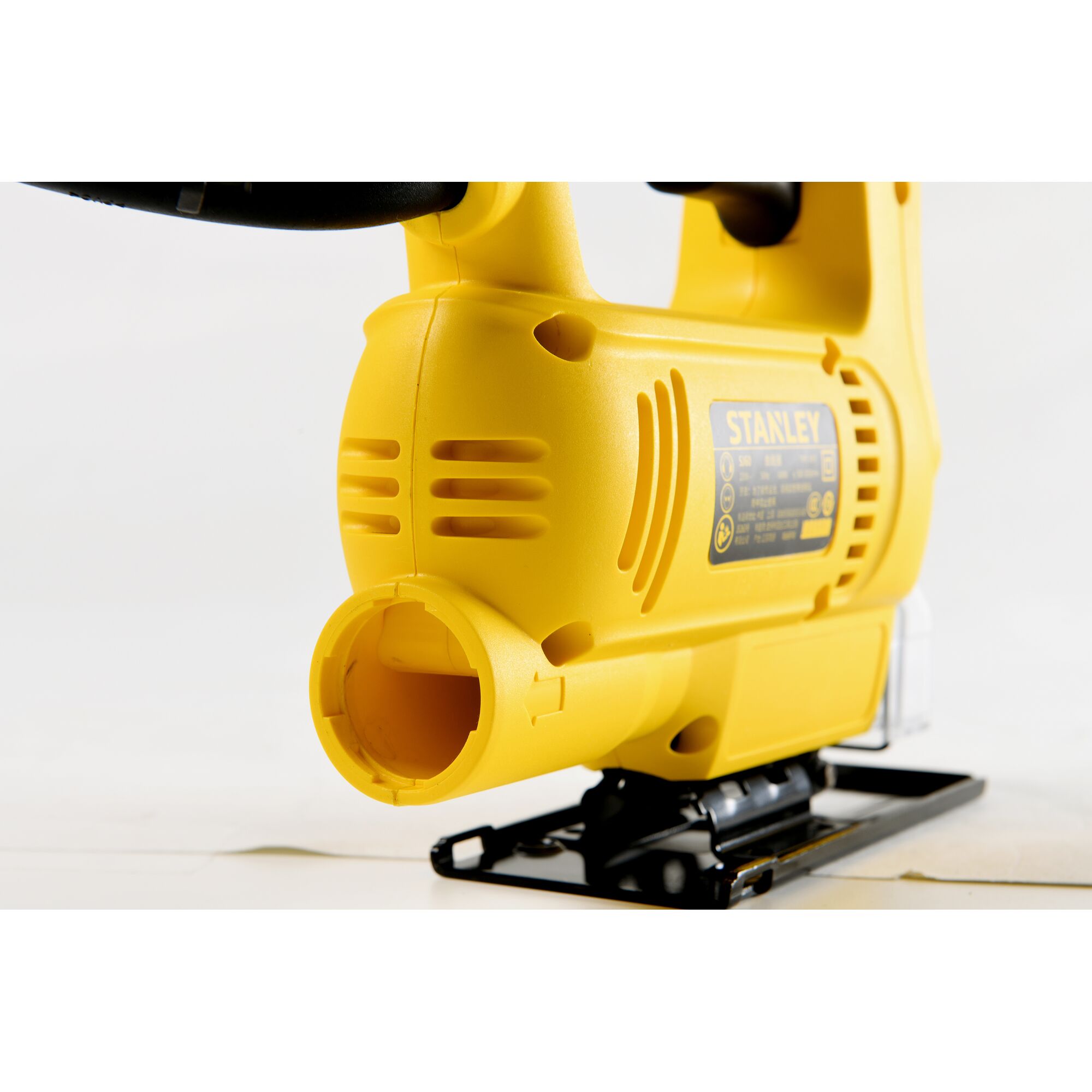 Photo of Stanley SJ60 yellow jigsaw side view on white background, showing vent and product label.