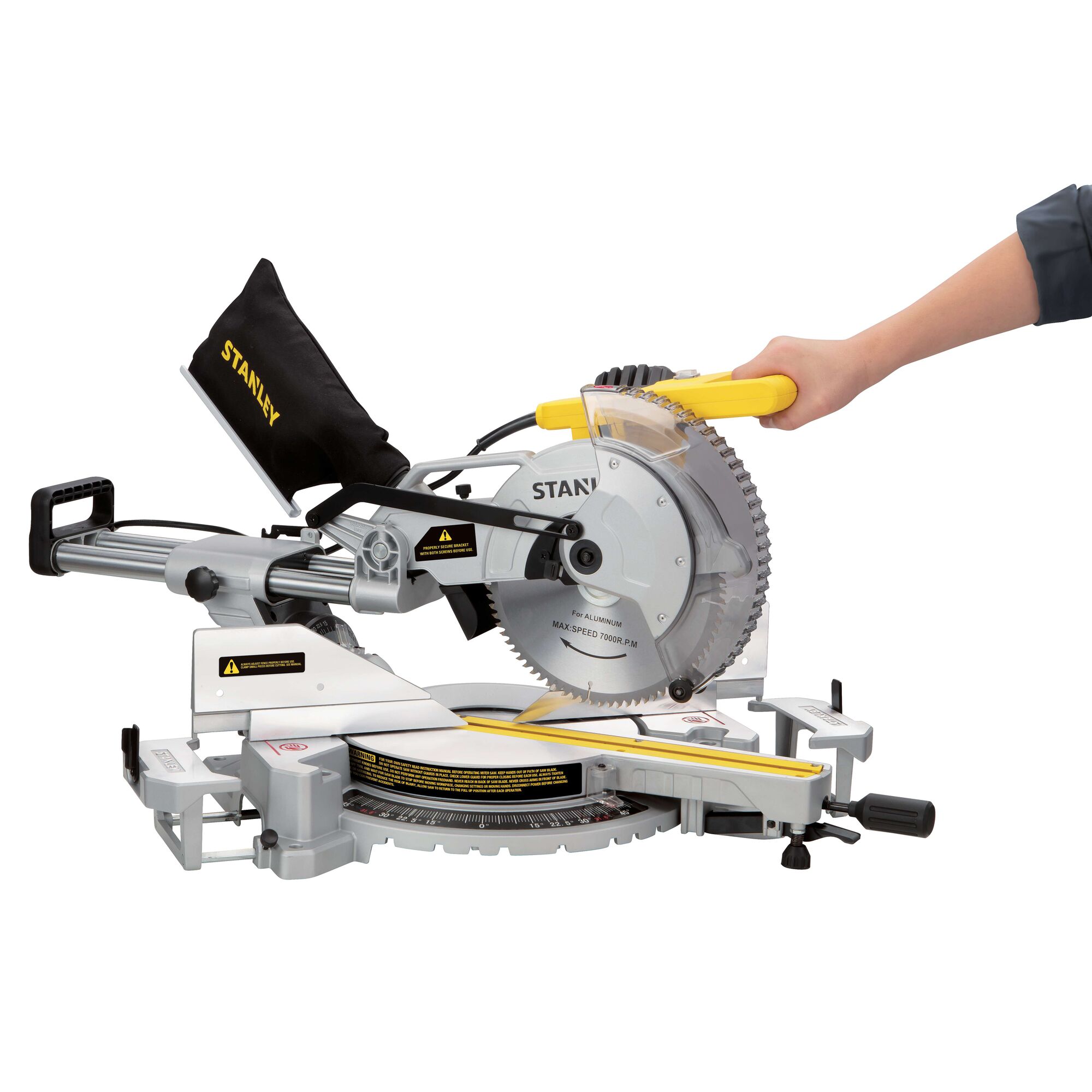 Photo of STANLEY SM18-B2C miter saw with dust bag, side view, a hand holding yellow handle.