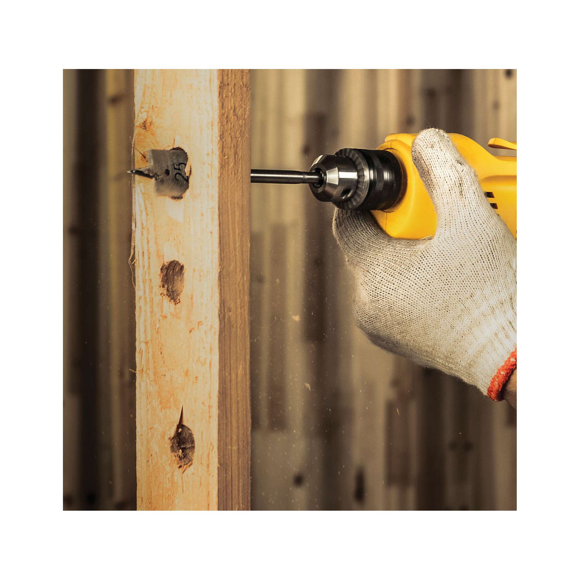 STANLEY STDR5510 drill in use, drilling wood beam, close-up photography, gloved hand holding tool.