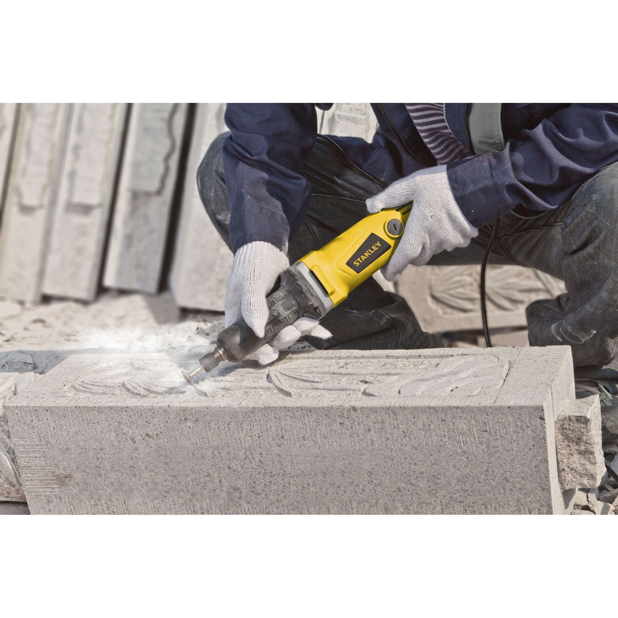 STANLEY STEL861 angle grinder used for stone carving, close-up in workshop.