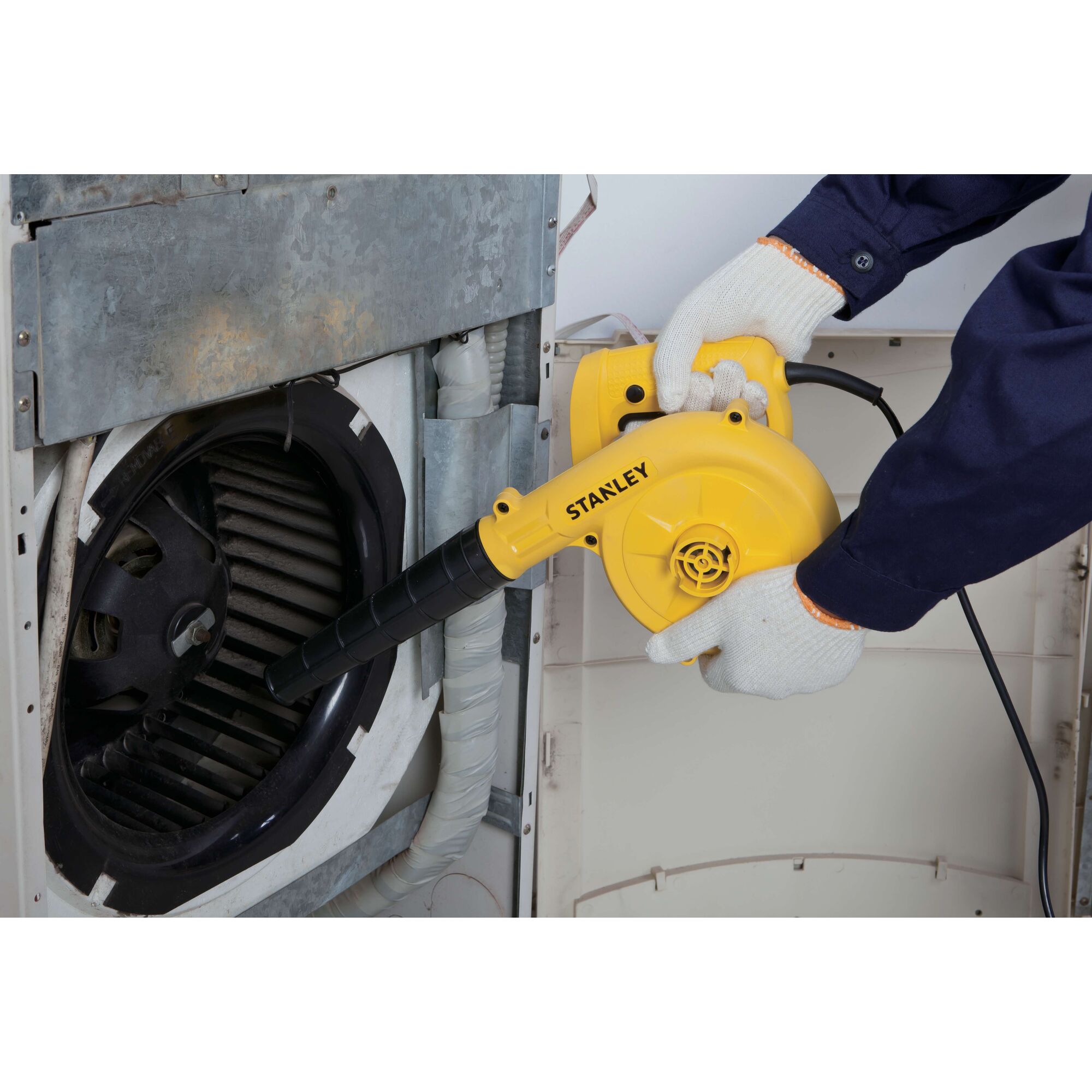 Photo of STANLEY STPT600-KR electric blower used for cleaning machine vents, yellow body, black nozzle.